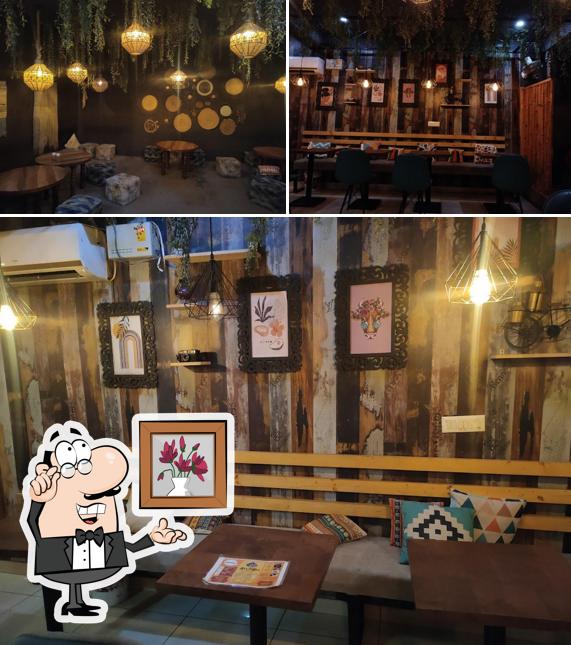 Take a seat at one of the tables at Guftgu Cafe cum Restaurant