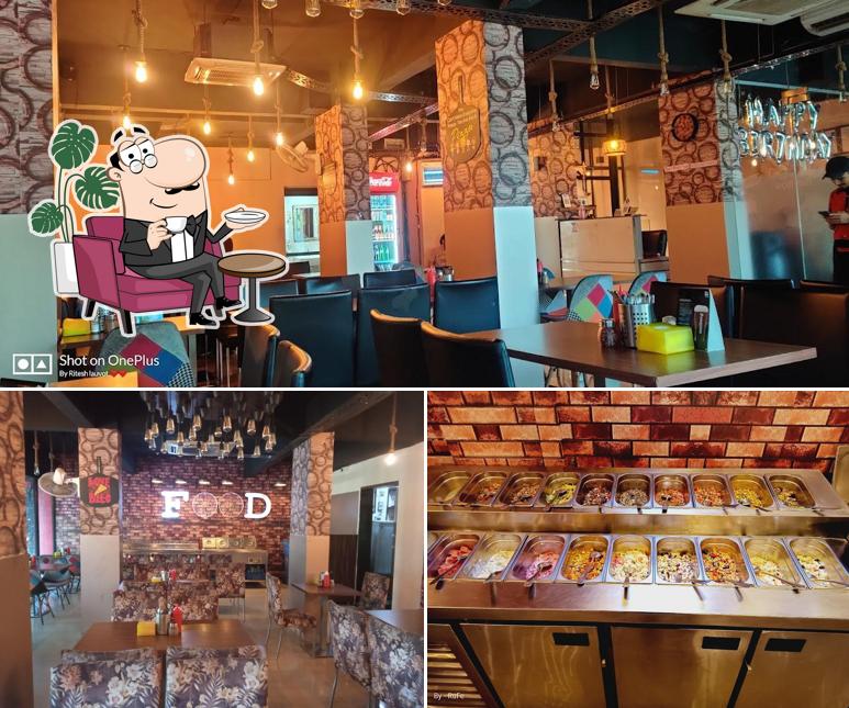Take a seat at one of the tables at Pizza Buffet Mira Road