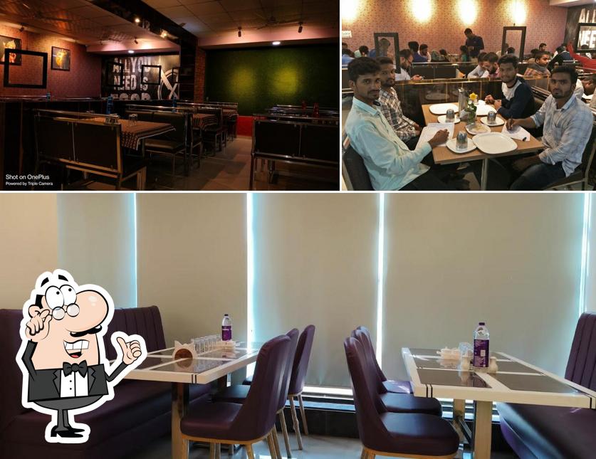 Take a seat at one of the tables at HOTEL SAI GRAND