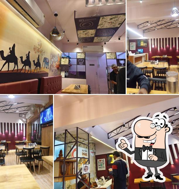 Take a seat at one of the tables at Atulyam Thal