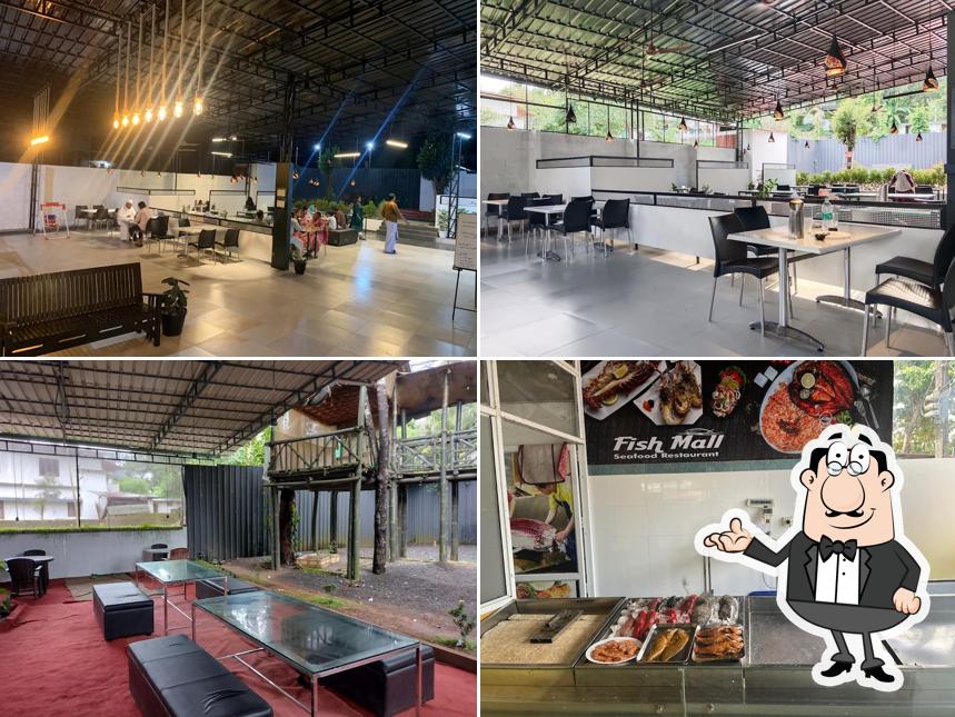 Take a seat at one of the tables at Fishmall SeaFood Restaurant