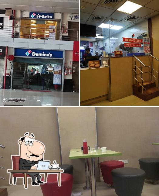 Take a seat at one of the tables at Domino's Pizza Khalasanagar Shopping Hub, Ghatlodia