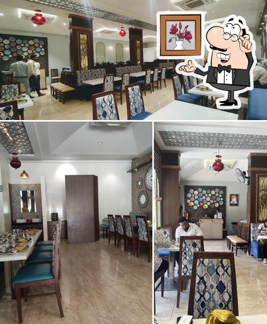 Take a seat at one of the tables at Chhappan Bhog Thali Restaurant