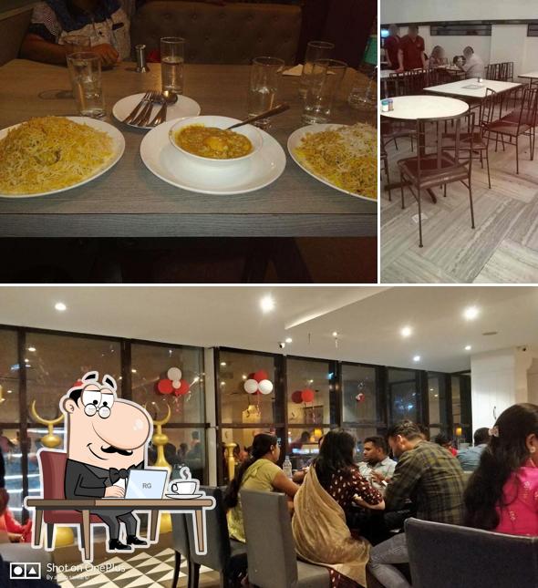 Take a seat at one of the tables at Aminia Restaurant - Rajarhat