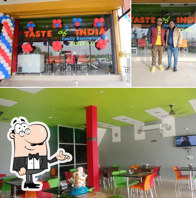 Take a seat at one of the tables at TASTE OF INDIA FAMILY RESTAURANT