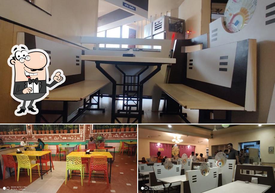 Take a seat at one of the tables at Hotel Angraj