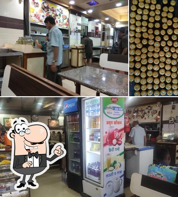 Take a seat at one of the tables at Adarsh Upahar Gruh & Dining Hall