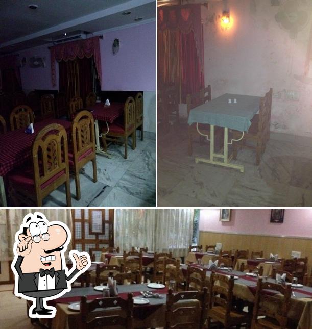 Among different things one can find interior and dining table at Hotel Sambit Palace