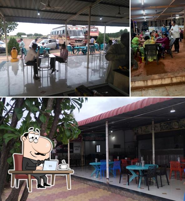 Take a seat at one of the tables at Rajapuri Hotel pure veg