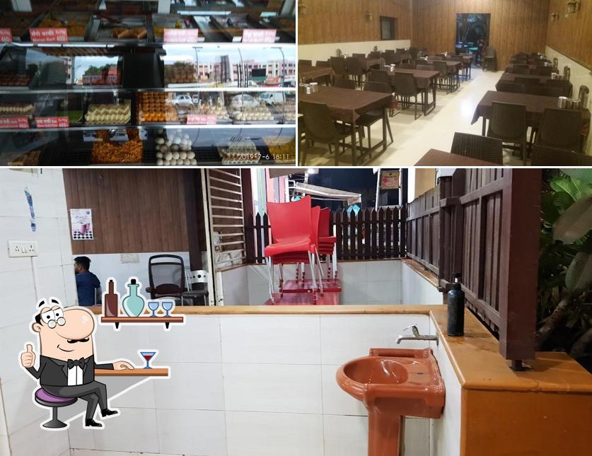 Take a seat at one of the tables at Hotel Sankalp Family Restaurant