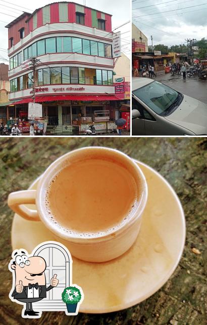This is the picture displaying exterior and beverage at Amantran Pure Veg & Lodging