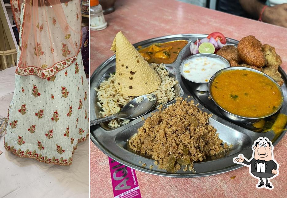 Take a seat at one of the tables at Agrawal Pavitra Bhojnalaya