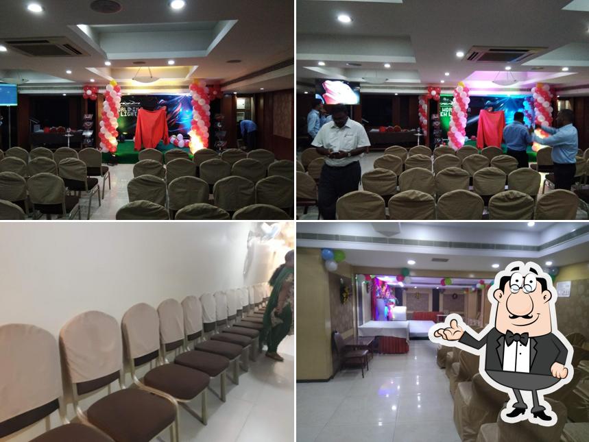 Take a seat at one of the tables at Hotel Geetha Regency