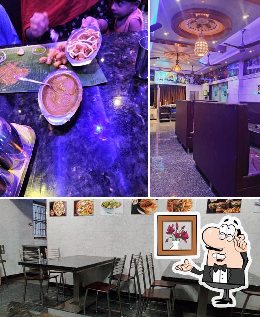 Take a seat at one of the tables at Tasty Veg Restaurant