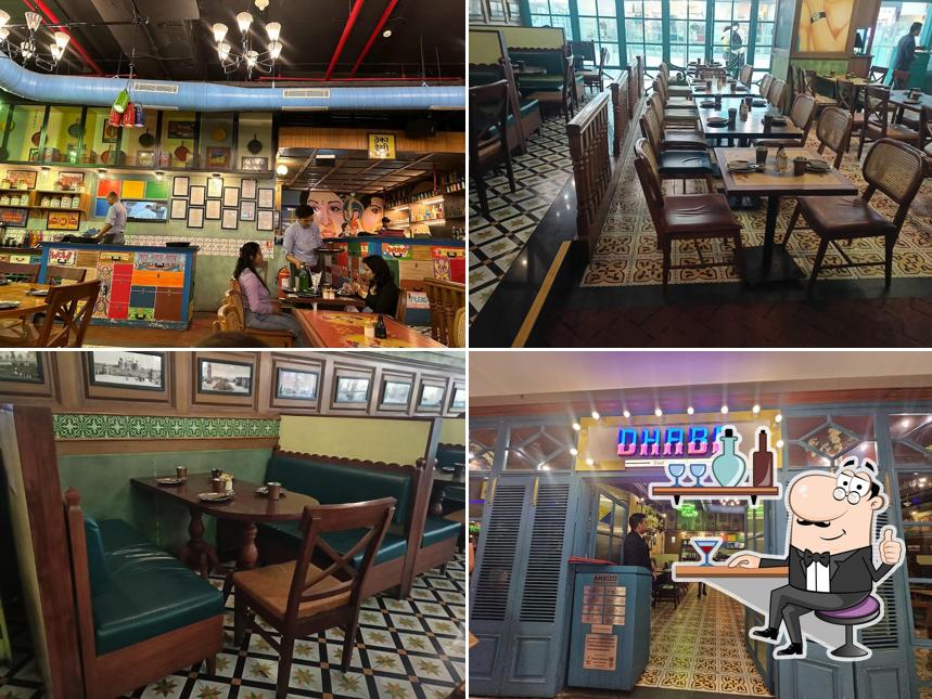 Take a seat at one of the tables at Dhaba Estd 1986 Delhi