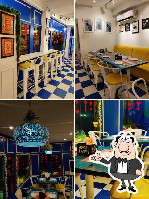 Take a seat at one of the tables at Happy Belly's Mehfil Restaurant ---A Multicuisine Restaurant