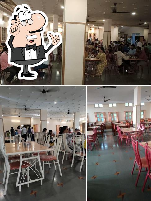 Take a seat at one of the tables at Anand Vihar Bhojnalaya