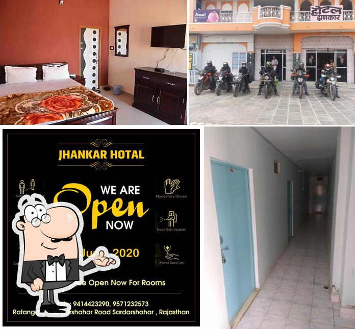 Take a seat at one of the tables at Hotel Jhankar & Restaurent Sardarshahar