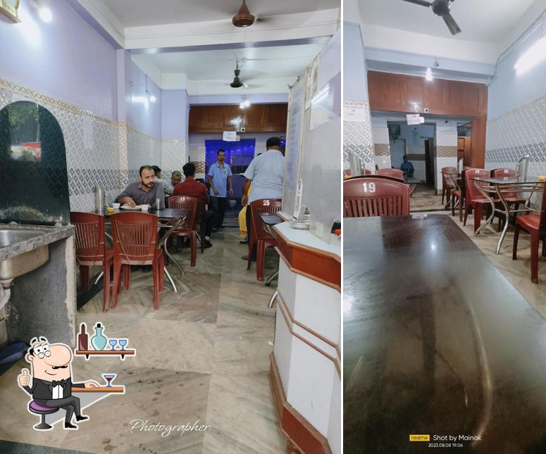 Take a seat at one of the tables at Suruchi Vegetarian Hotel