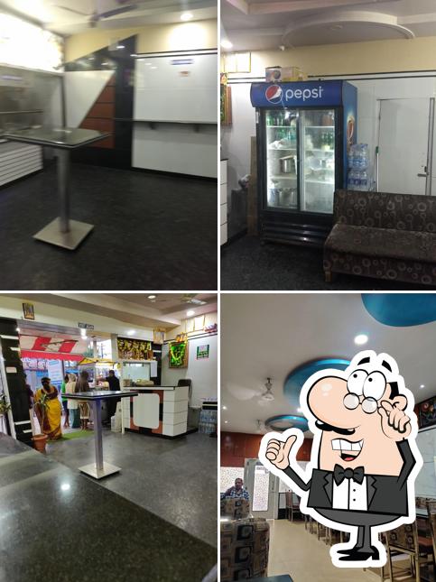 Take a seat at one of the tables at Raghavendra Restaurant