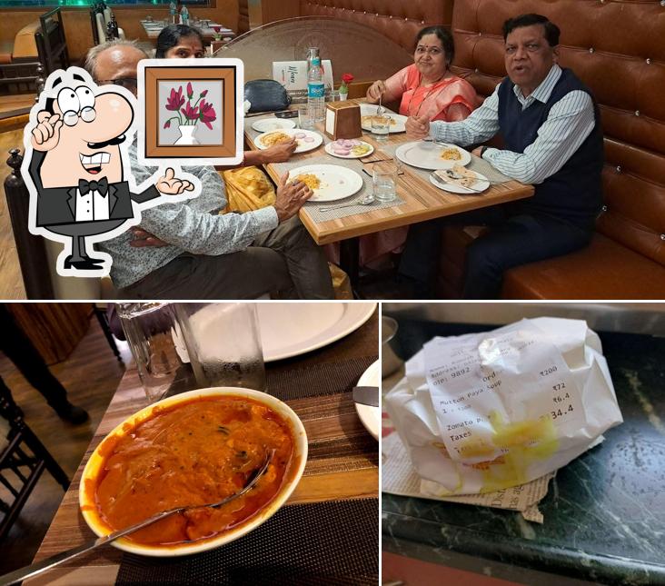 Take a seat at one of the tables at Yahoo Hotel Restaurant & Bar Nashik