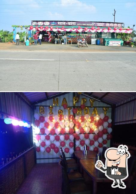 Take a seat at one of the tables at Hotel New SAT-BARA, Family Rsto & Dabha