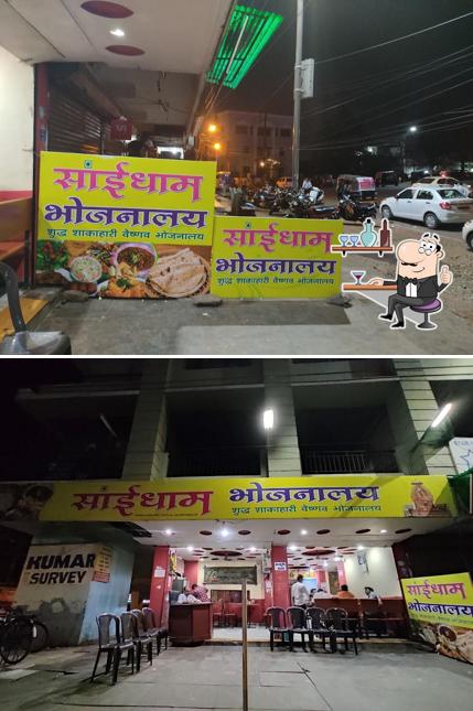 Take a seat at one of the tables at Saidham Bhojnalay