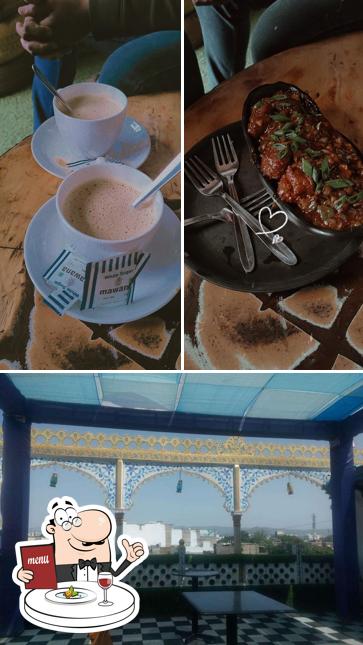 Check out the picture depicting food and dining table at Step 51 Rooftop Cafe - Cafe In Hiran Magri Udaipur