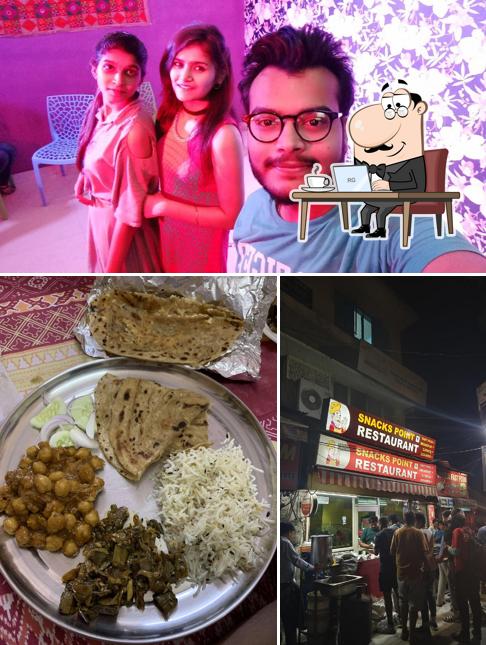 Take a seat at one of the tables at Snacks Point Veg Restaurant