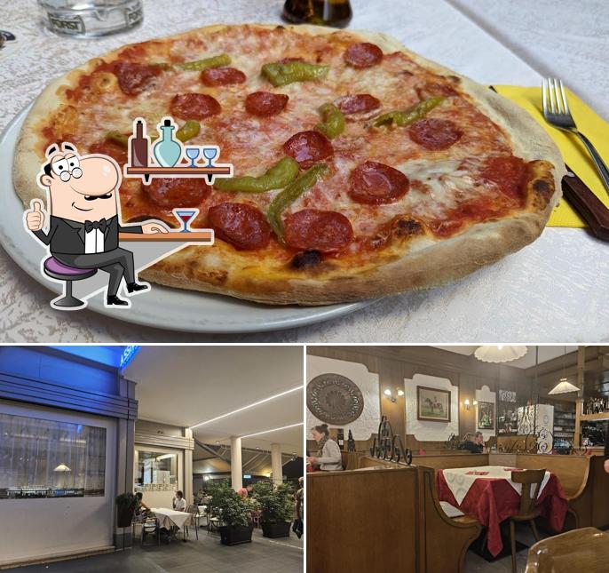 Questa è la foto che presenta la interni e pizza di Pizzeria Abc