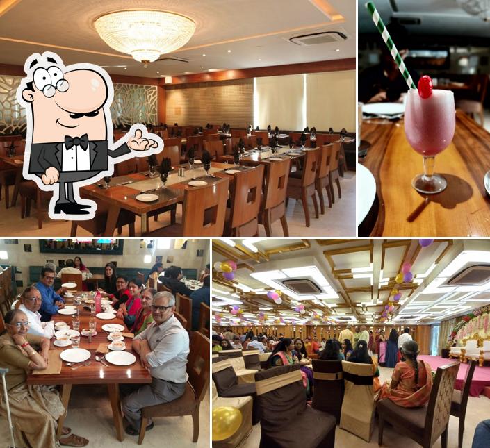 Take a seat at one of the tables at BONHOMIE RESTAURANT & BANQUET VASTRAPUR