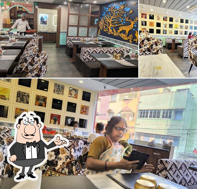 Take a seat at one of the tables at Kasturi Restaurant