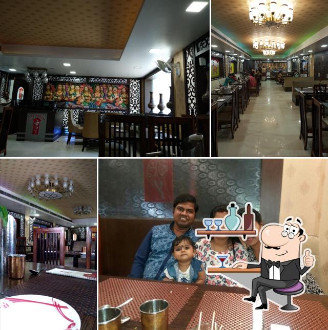 Take a seat at one of the tables at Ghar Aangan Restaurant