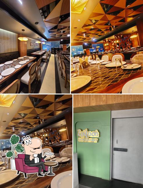 Take a seat at one of the tables at Zaitoon The Multi Cusine Restaurant