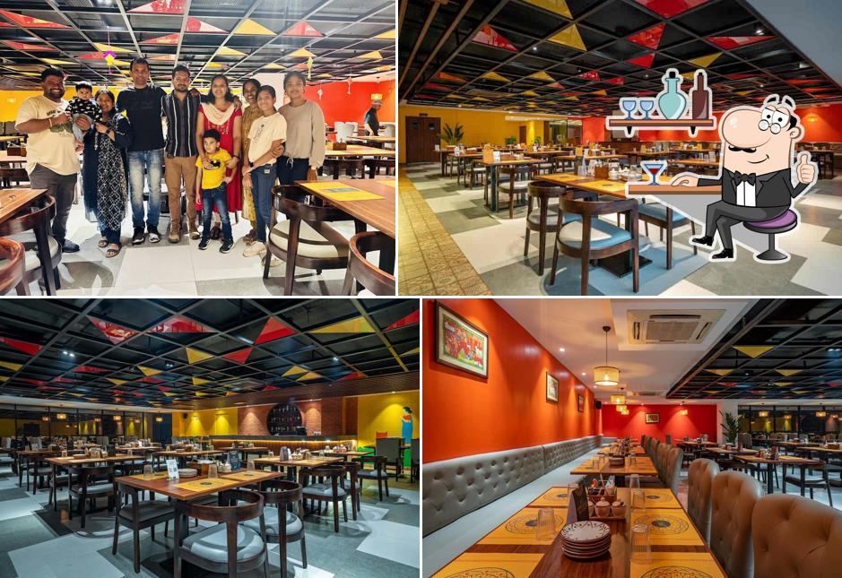 Take a seat at one of the tables at Naatu Kitchen And Bar