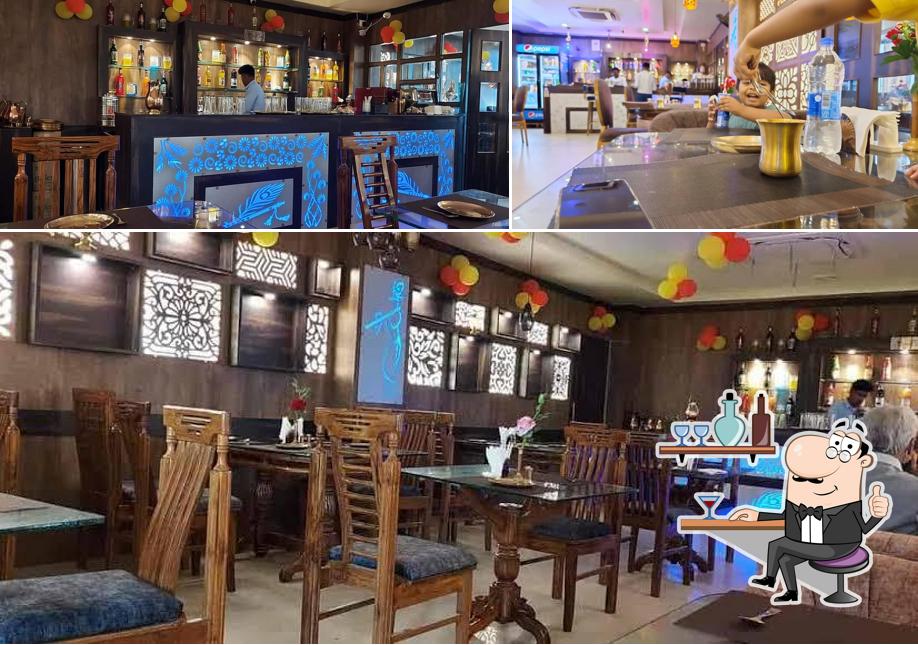 Take a seat at one of the tables at Ganga Ram - Family Restaurant (Pure Veg)