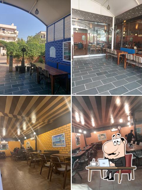 Take a seat at one of the tables at Dhaba Delight (Veg Restaurant)