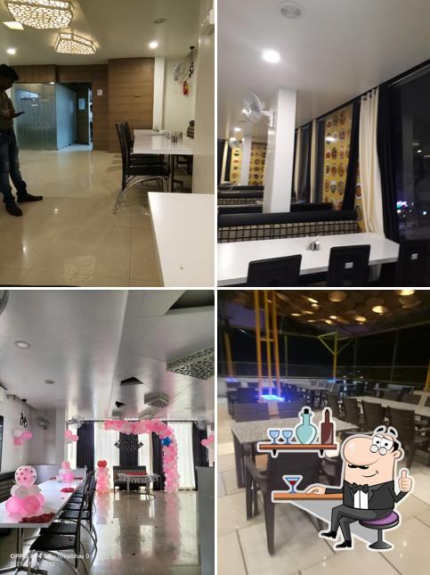 Take a seat at one of the tables at Atmosphere Pure Veg Restaurant & Cafe