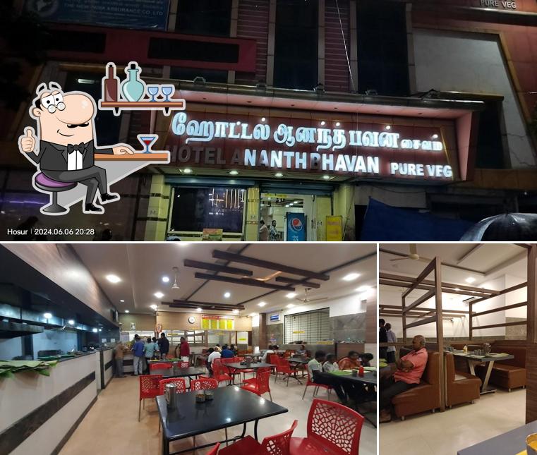 Take a seat at one of the tables at Hotel Sri Ananth Bhavan Amirtham