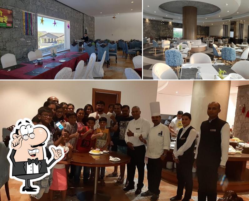 Take a seat at one of the tables at Pangat -Multi Cuisine Vegetarian Restaurant at Raajsa Kumbhalgarh IHCL SeleQtions