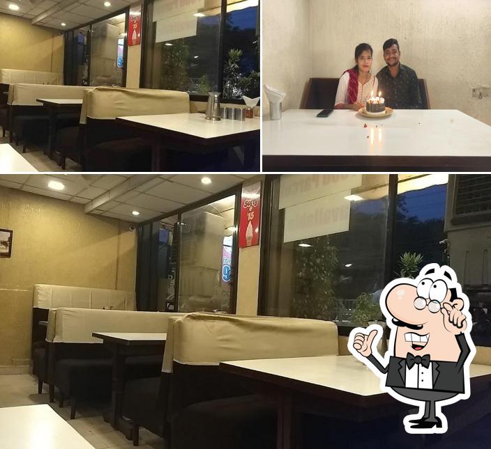 Take a seat at one of the tables at New Sudama Restaurant