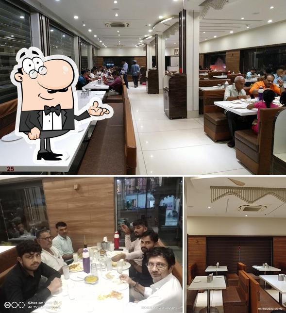 Take a seat at one of the tables at HOTEL TULSI