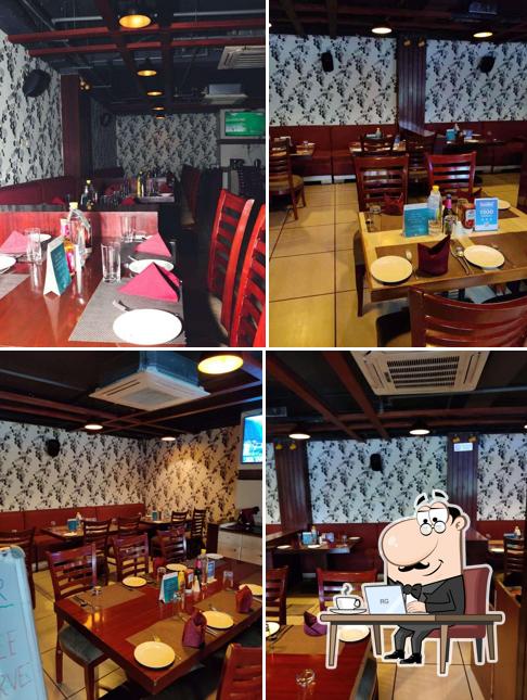 Take a seat at one of the tables at Cinch Restaurant & Lounge Bar