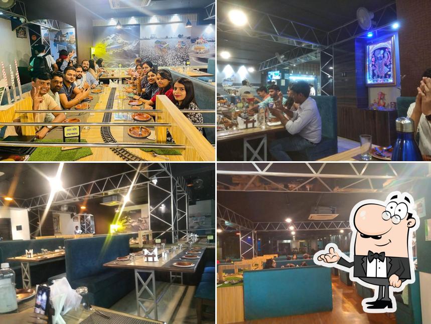 Take a seat at one of the tables at India Junction Veg Family Restaurant