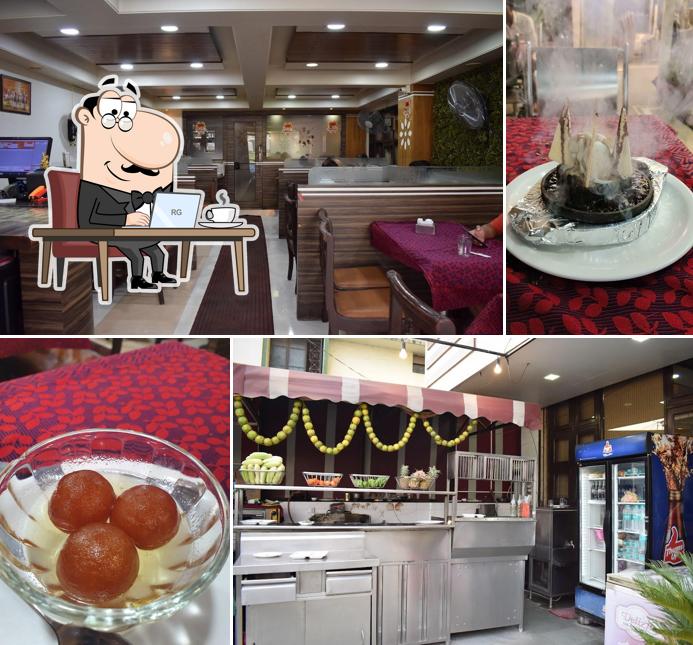 Take a seat at one of the tables at Amrita Pure Veg Restaurant