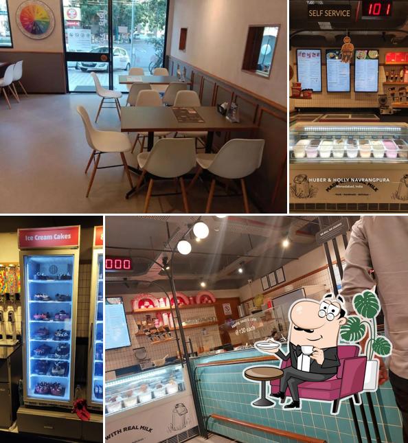 Take a seat at one of the tables at Huber & Holly (Vijay Cross Roads)