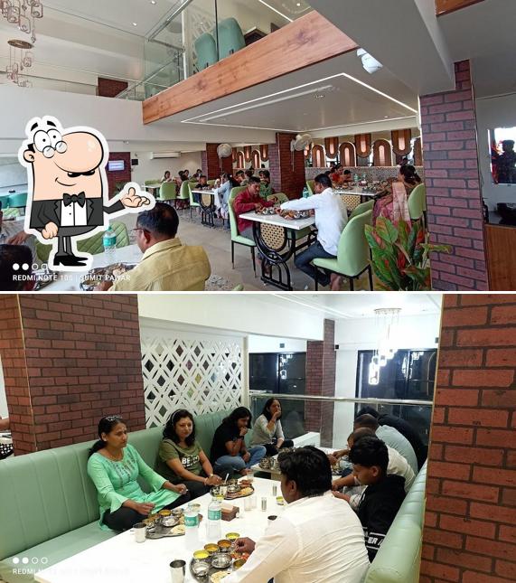 Take a seat at one of the tables at Hotel Mauli Prasad