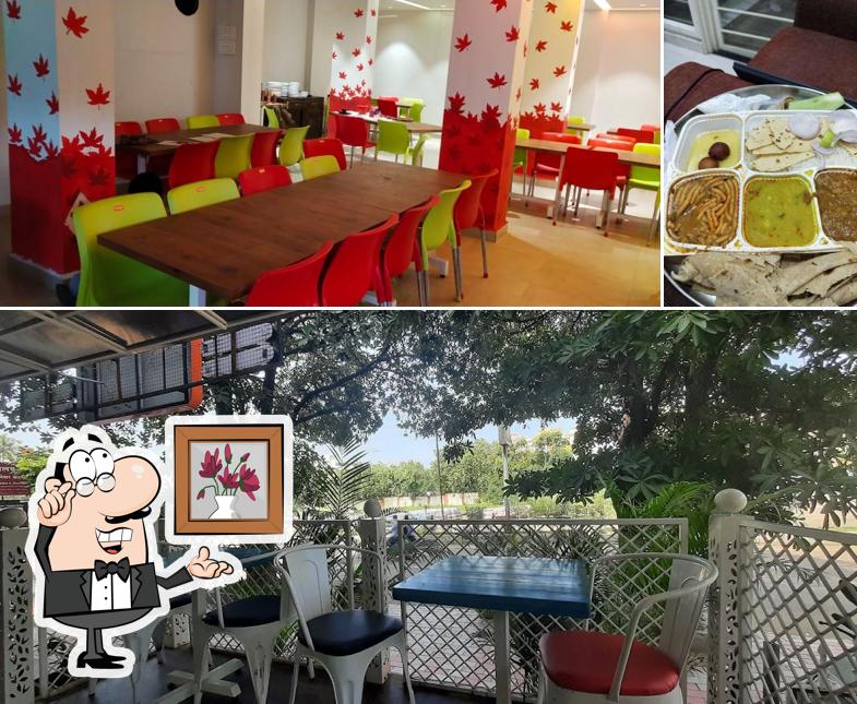 Take a seat at one of the tables at Brahmand Pure Veg Restaurant