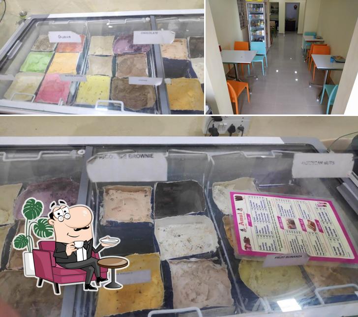 Take a seat at one of the tables at Amul Icecream Parlour