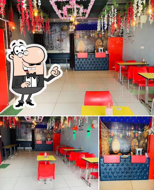 Take a seat at one of the tables at Hottely Pizza And Cafe